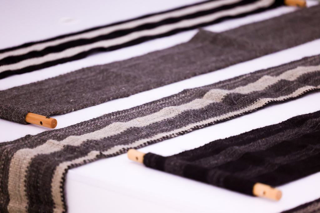 Shades of Yak. These decorative cloths are meticulously handwoven from authentic yak fabric, honoring traditional techniques passed down through generations in the highlands of Tibet. Each piece reflects the artisans' dedication to preserving their culture while creating unique, sustainable textiles.